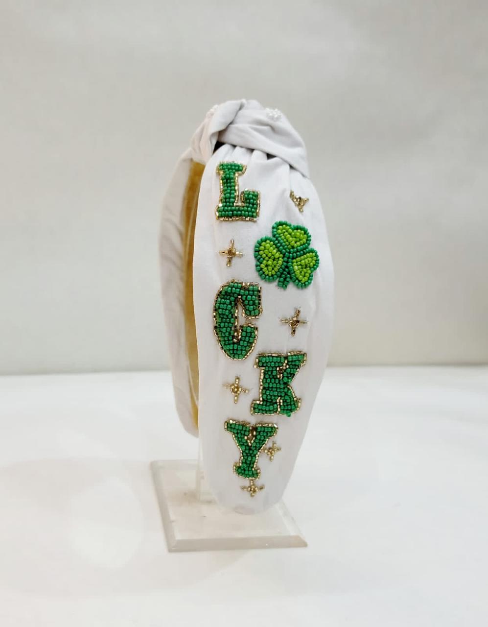 "Lucky" St. Patrick’s White Headband with Green Flower Accent